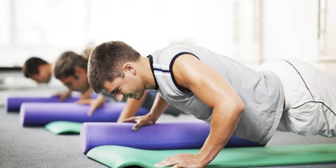 Group of young people doing Pilates exercises.